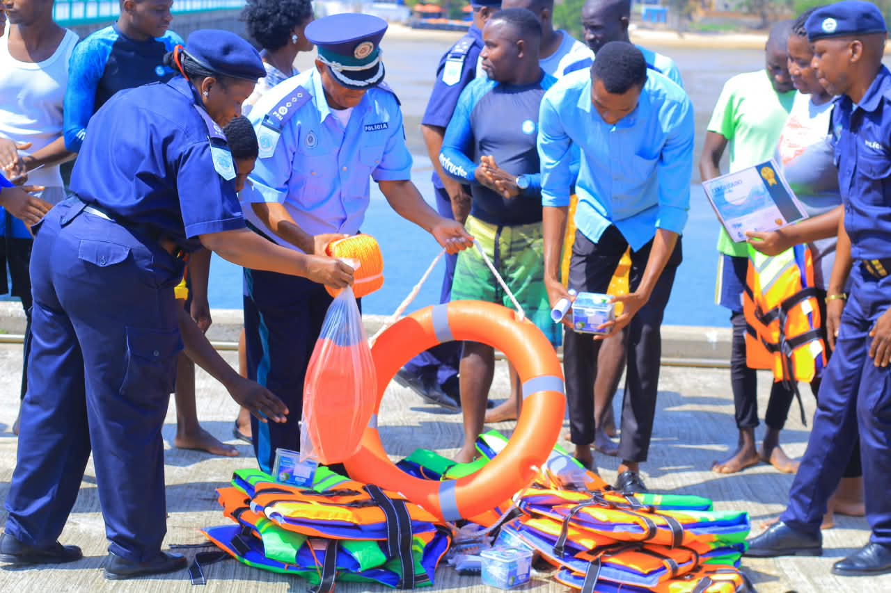 Coastal Police officers hand out life jackets, a life ring, and other rescue equipment laid out on the ground