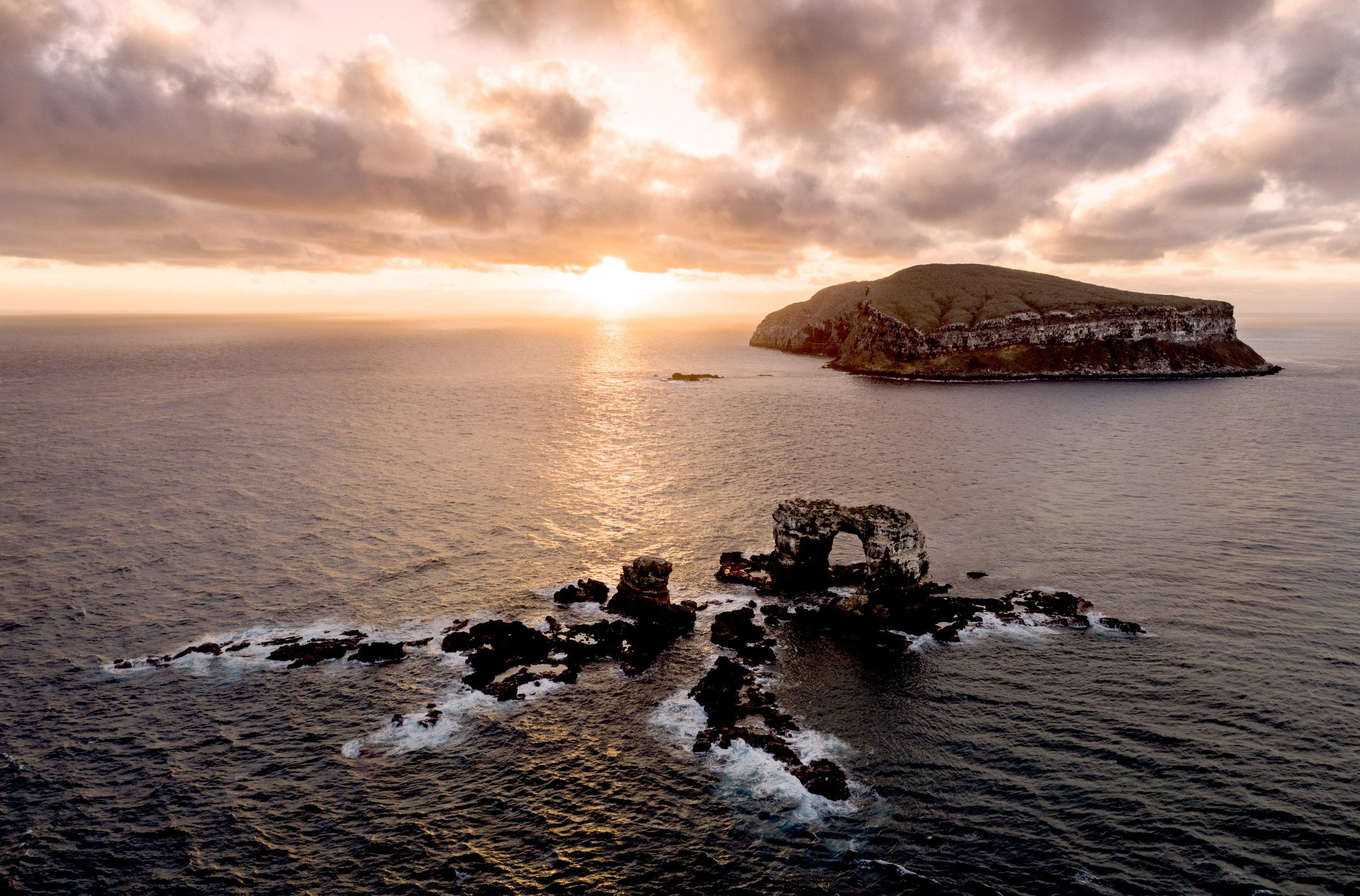 Darwin's Arch at sunrise, with Darwin Island behind, in the northern Galapagos