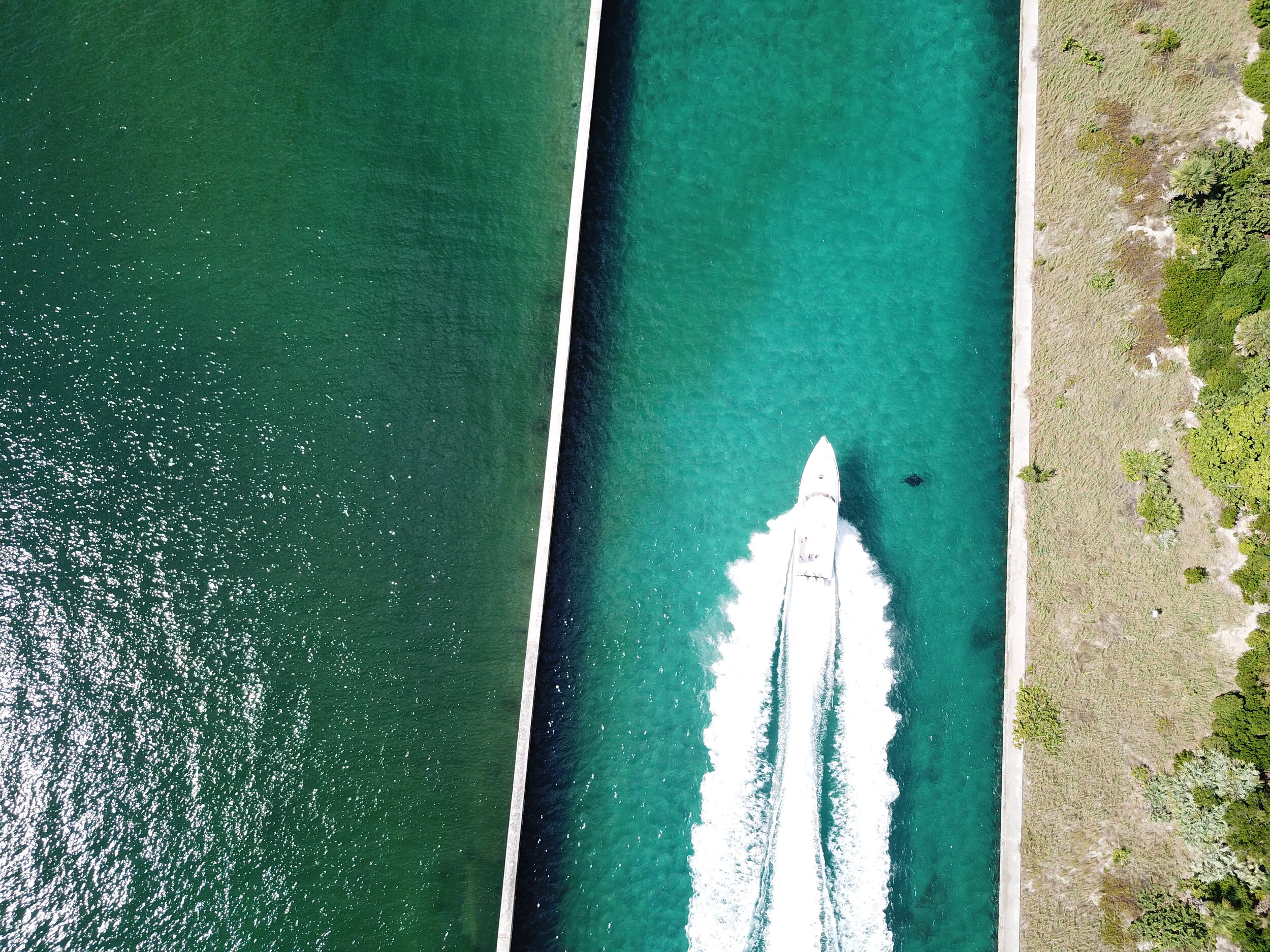 A boat heads out through Boynton Inlet, seen from above