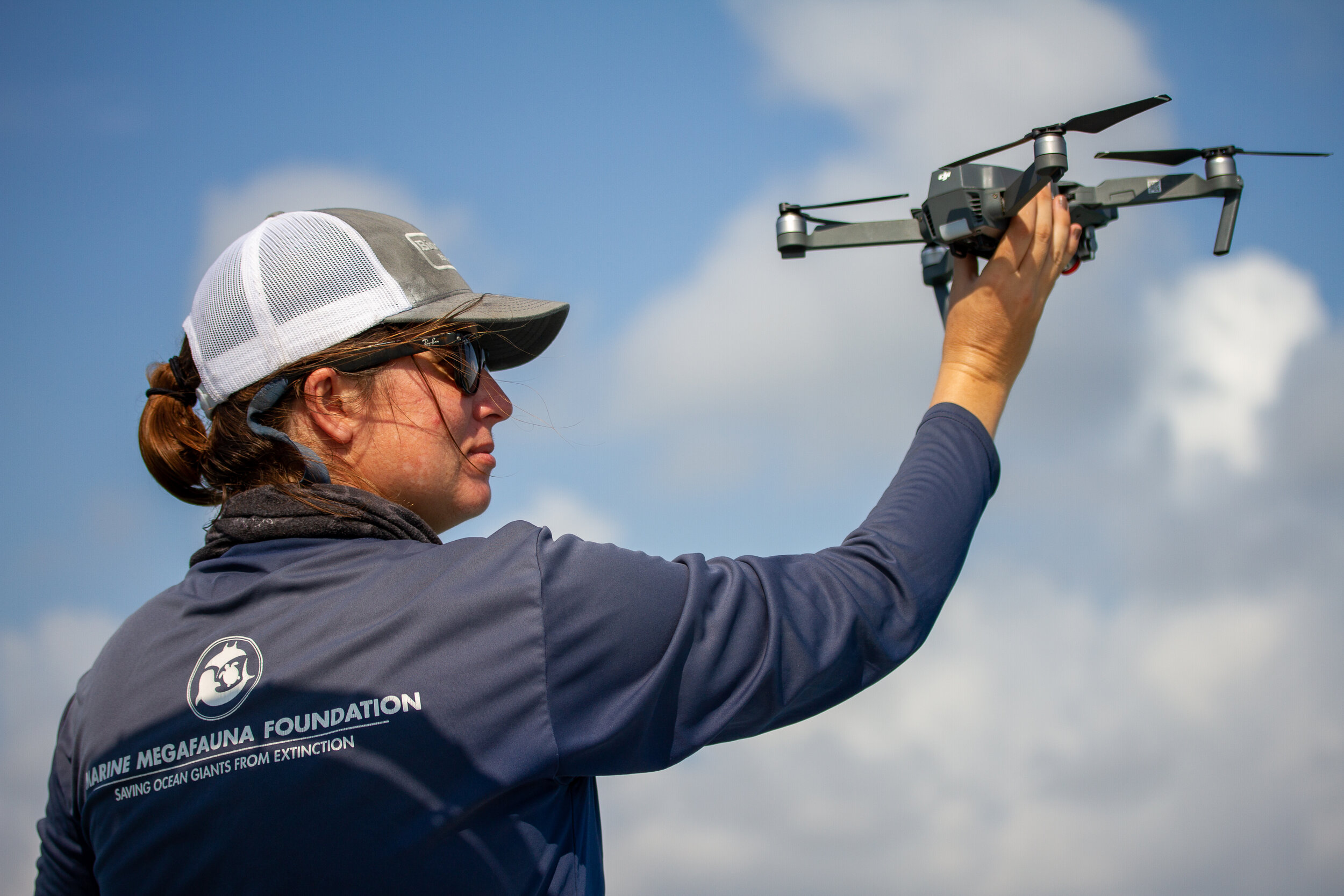 Jessica Pate launches a research drone by hand