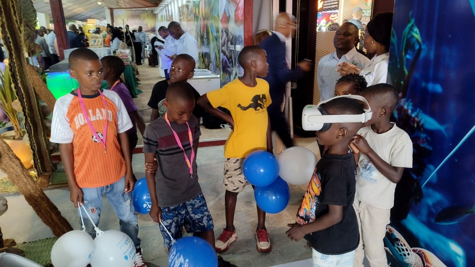 Children wearing virtual reality headsets at the Inhambane Province stand