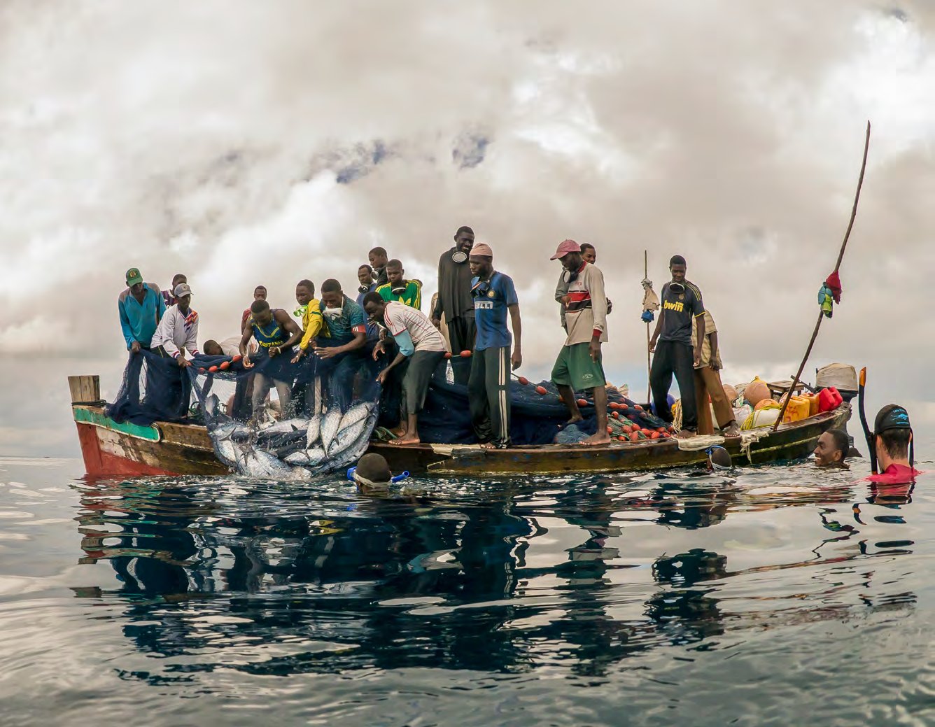 A whale shark alongside a local fishing boat